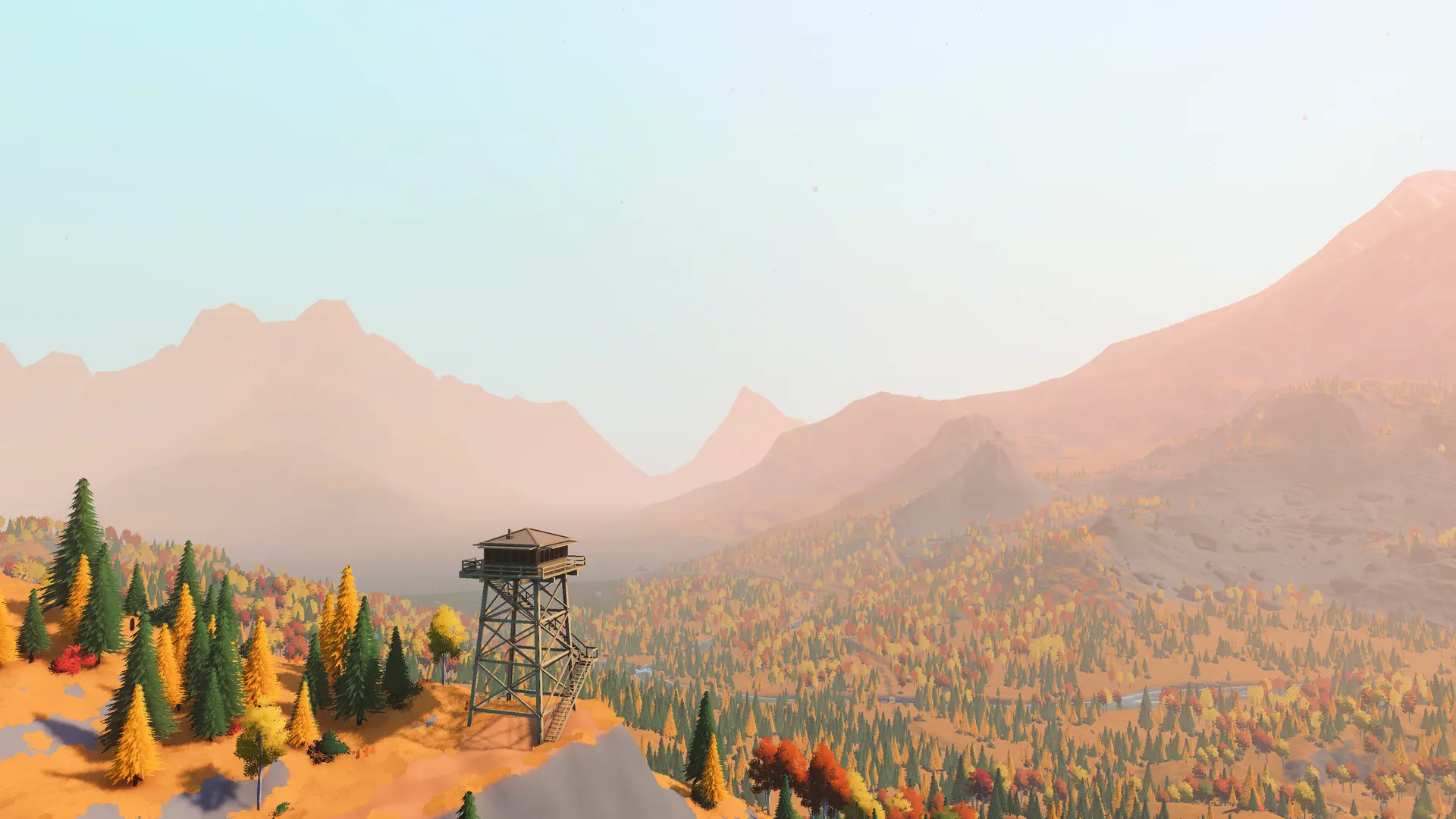 A fire lookout tower above an autumn forest in over the hill